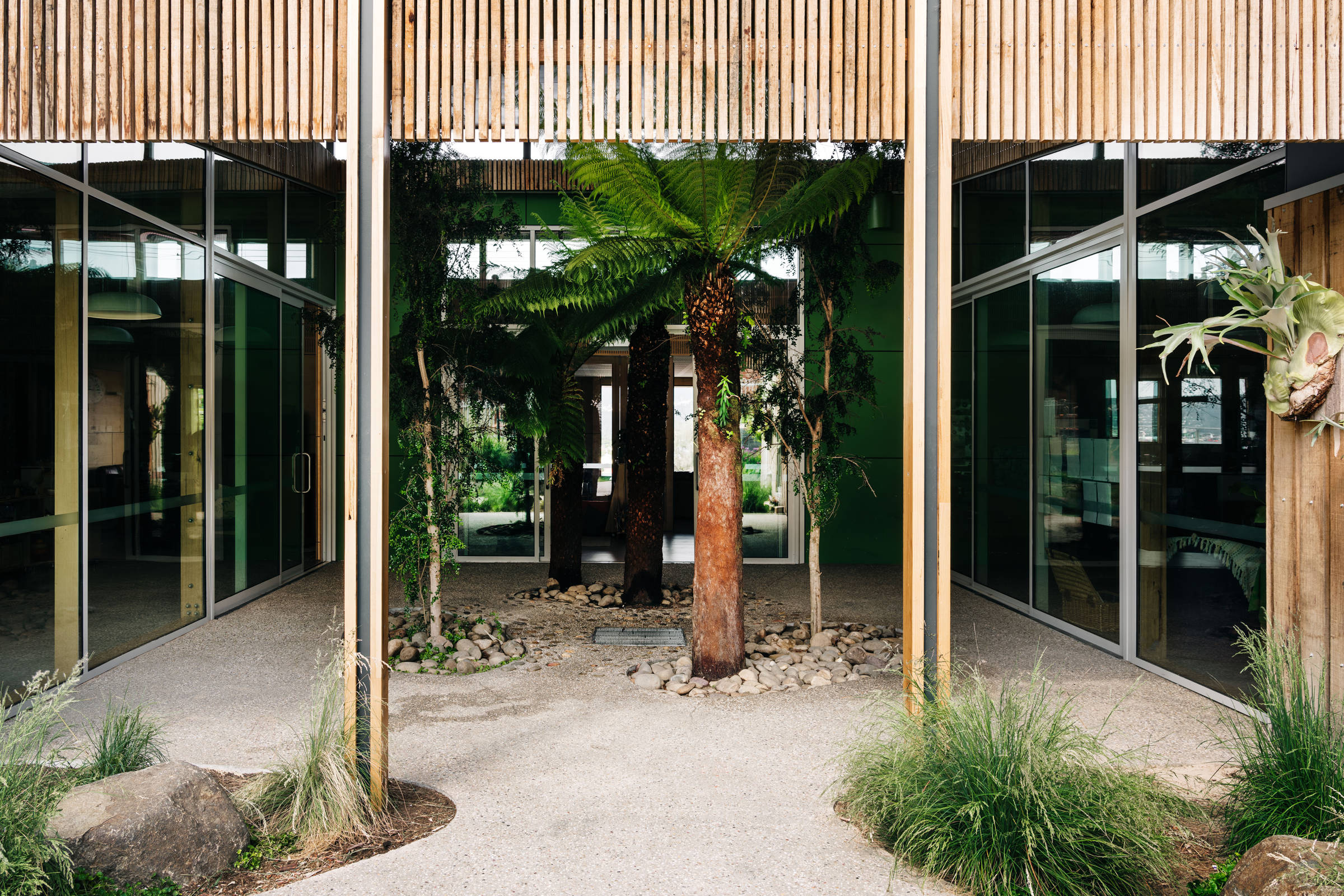 St Cuthbert’s Early Years – Catholic Education Tasmania: Timber screens and pebbled slabs evoke the natural environment providing textural detail where the built environment becomes the Third teacher. Photo by Adam Gibson. Photo by Adam Gibson.