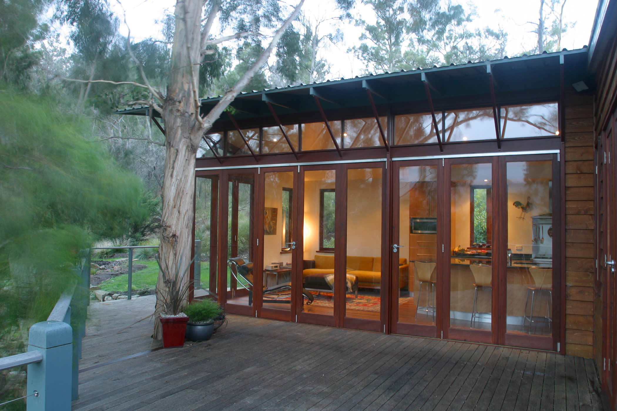 House Butler Extension: Glazed recycled hardwood (mixed eucalyptus) timber bi-fold doors and high-level windows bring the outside in. Photo by Peter Whyte.