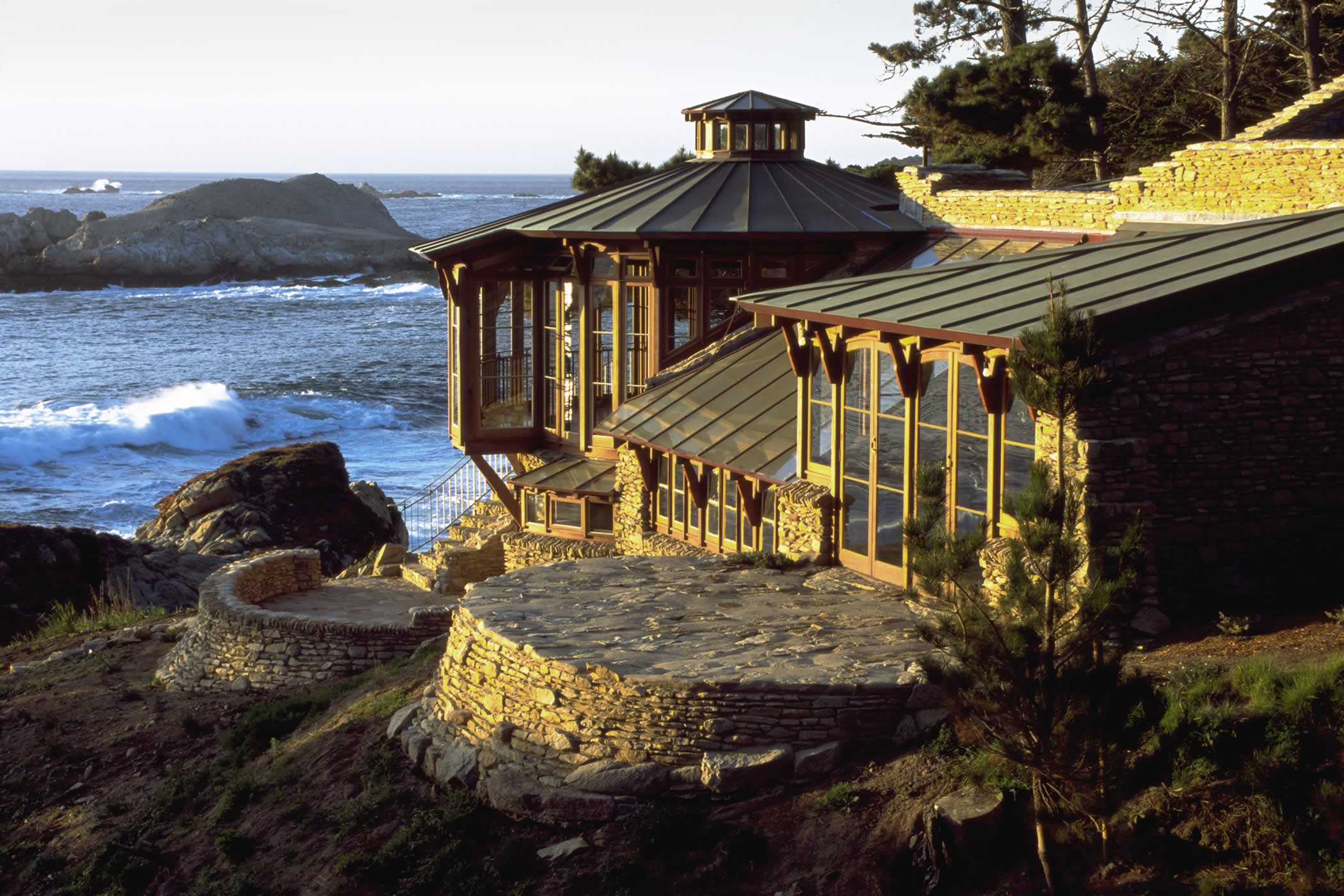 The James House Greenhouse, Carmel Highlands, California: The stone and recycled timber greenhouse with copper and glass roofs and curved stone external patios looks out to spectacular Point Lobos State Reserve. Photo by James Morrison.
