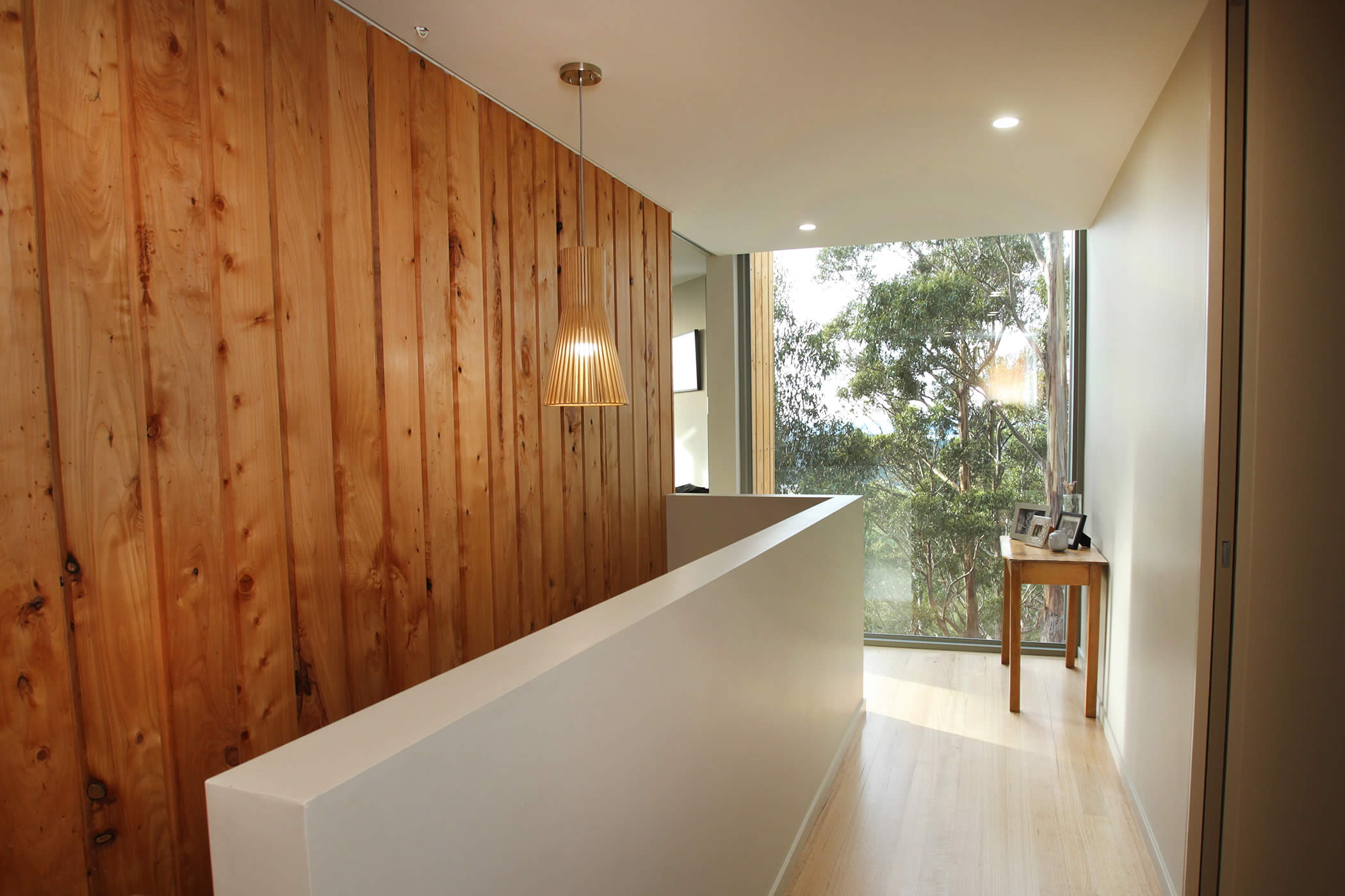 Jamieson Road Residence, Tasmania: We create a memorable effect from the entrance hall by use of natural timber combined with beautiful views through leafy eucalypts to emphasise a natural aesthetic and the country context. Photo by R. Lovell.