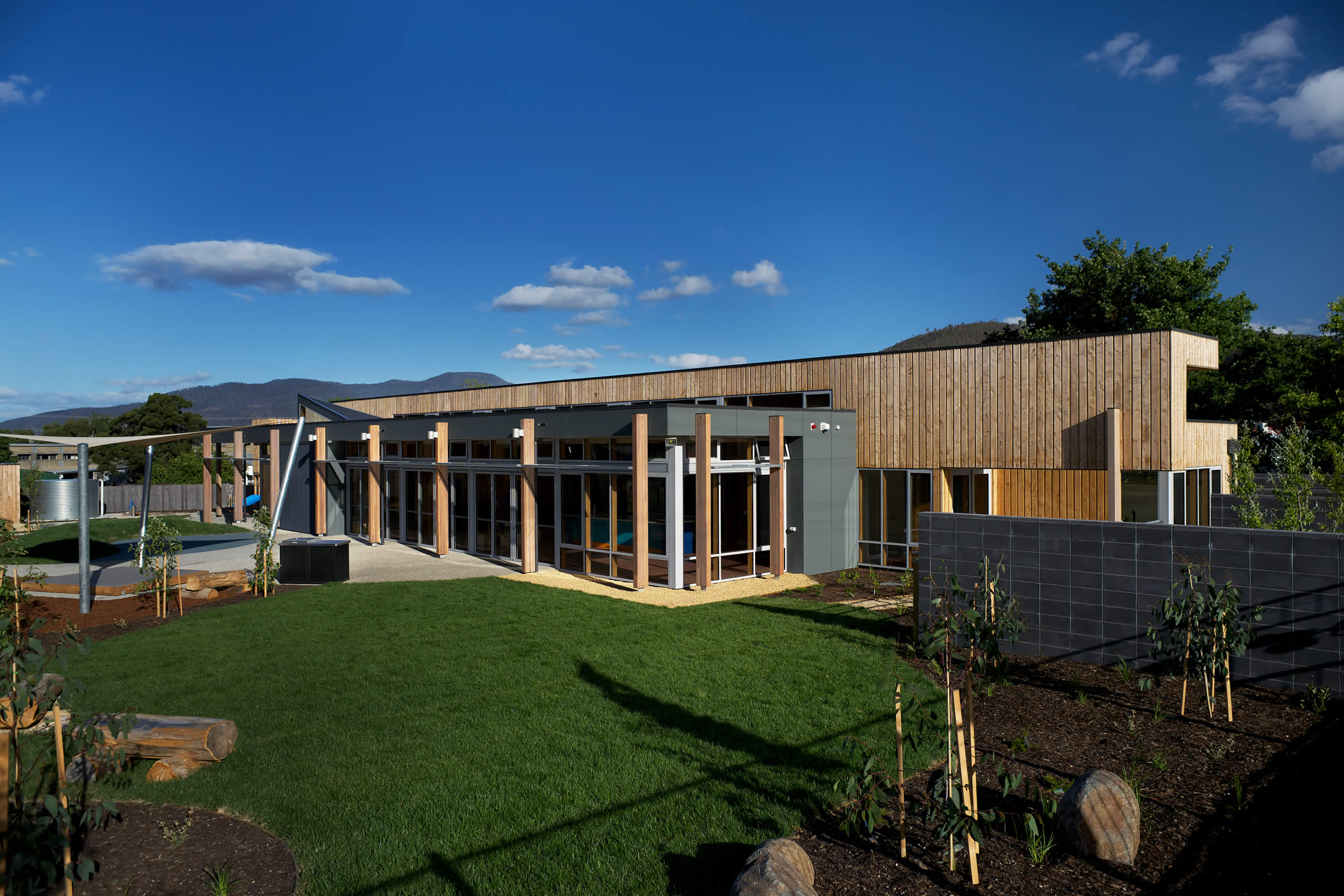 Ptunarra Child and Family Centre (CFC), New Norfolk, Tasmania: The external facades are clad in macrocarpa timber with minimal applied finishes to achieve the building’s low carbon footprint. Photo by Ray Joyce.