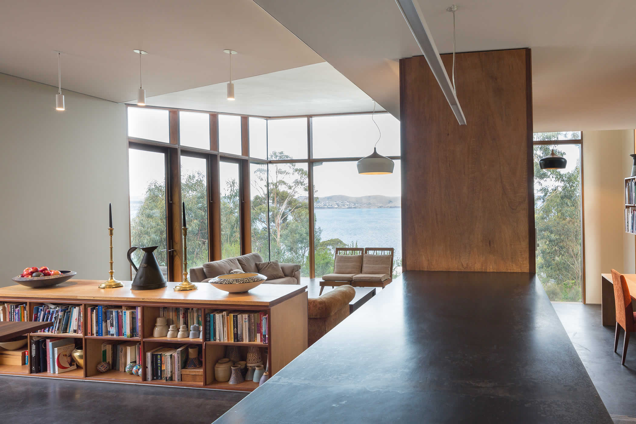 Sandy Bay, Tasmania: The main pavilion opens to the courtyards and different views. Floor and ceiling levels, alcoves and clever storage define interlinked dining, living, study, kitchen and pantry / laundry space. Photo by Thomas Ryan.