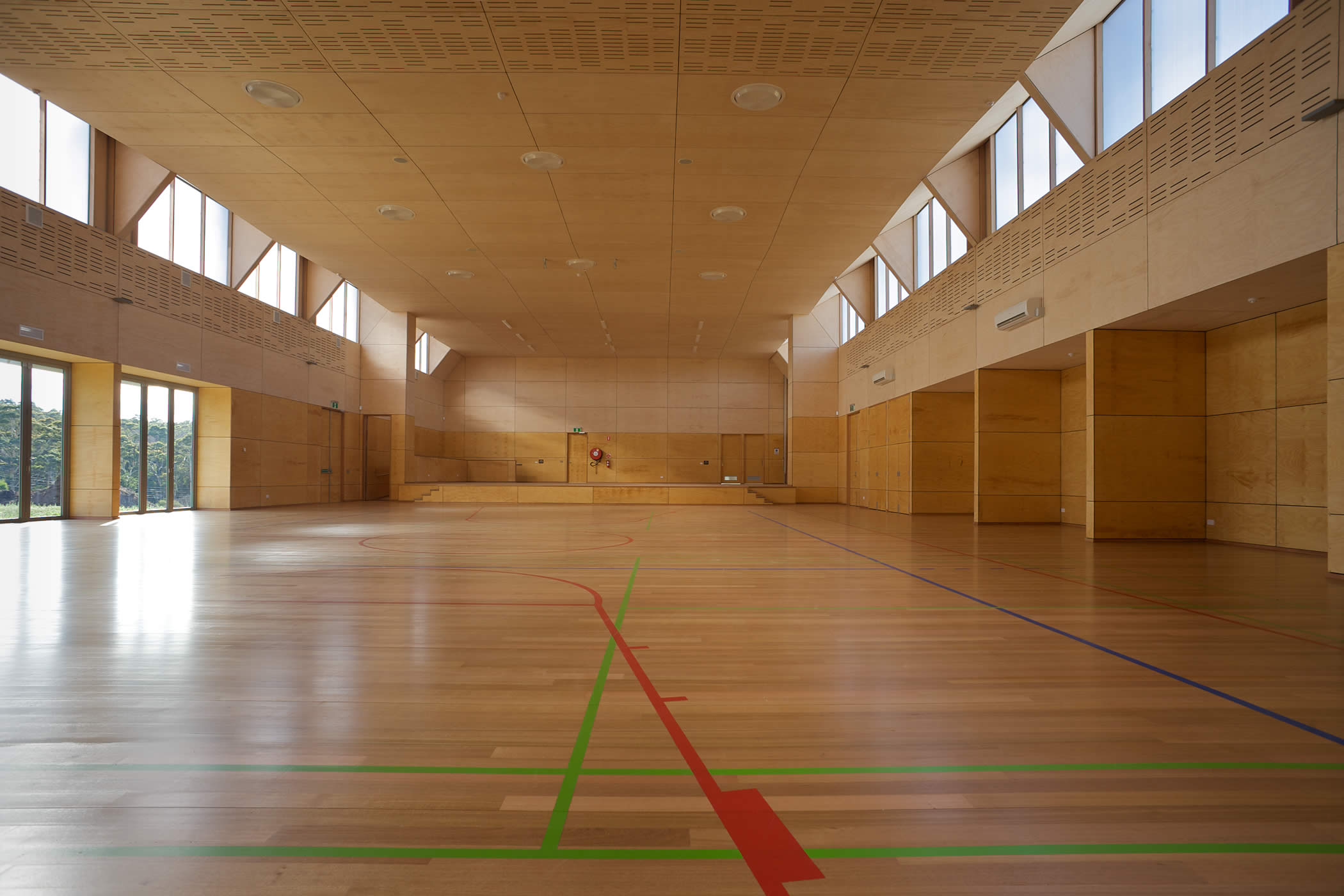 Tarremah School Hall, Kingston, Tasmania: The economical carbon sink timber structure achieves large clear spans, and incorporated a sprung timber floor and an acoustically engineered plywood interior for multifunctional use.  Photo by Ray Joyce.