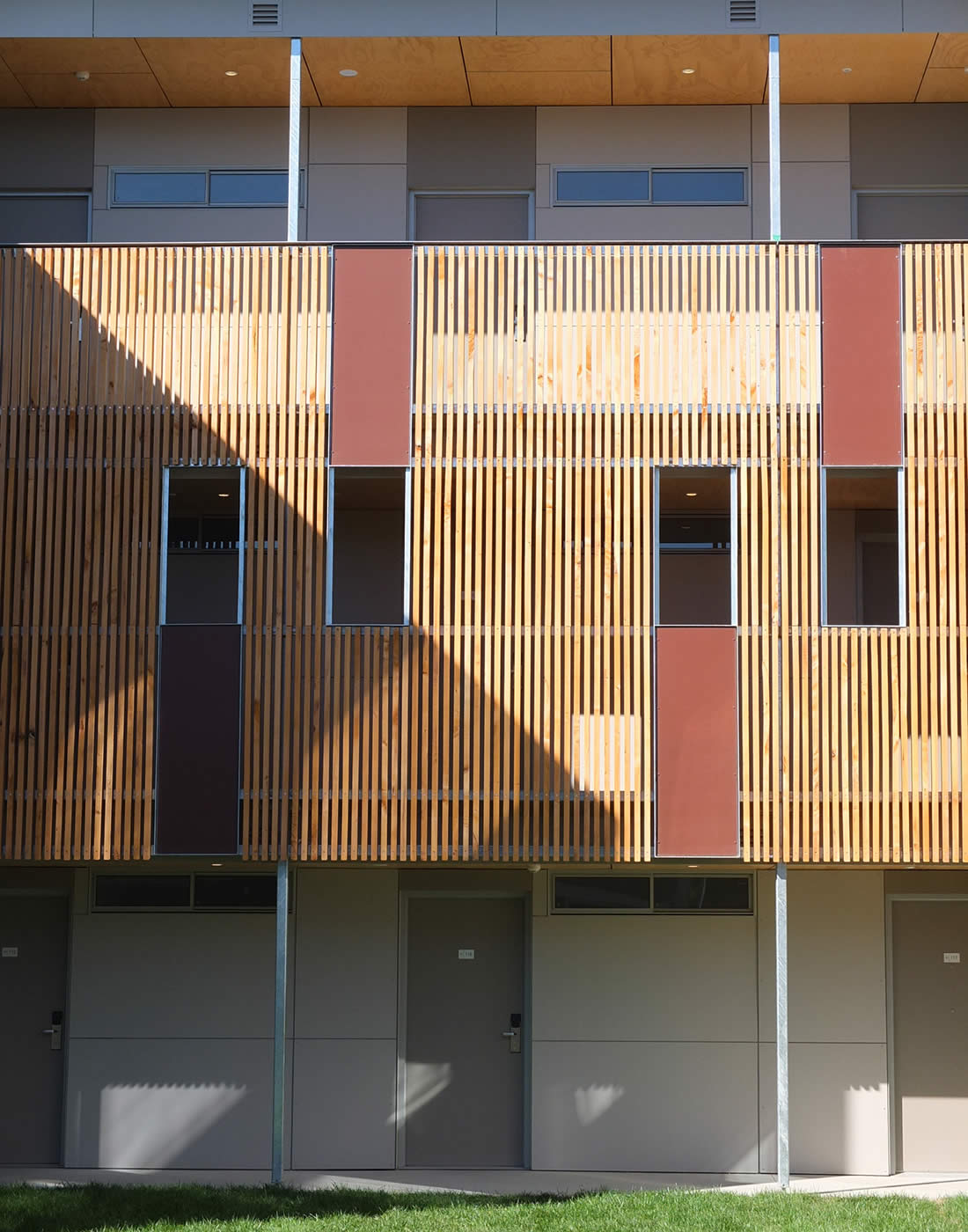 UTAS Newnham Student Residences, Tasmania: Rough sawn unfinished macrocarpa timber screens moderate the weather to open walkways and support crime prevention through environmental design (CPTED) principles. Photo by Morrison & Breytenbach Architects.