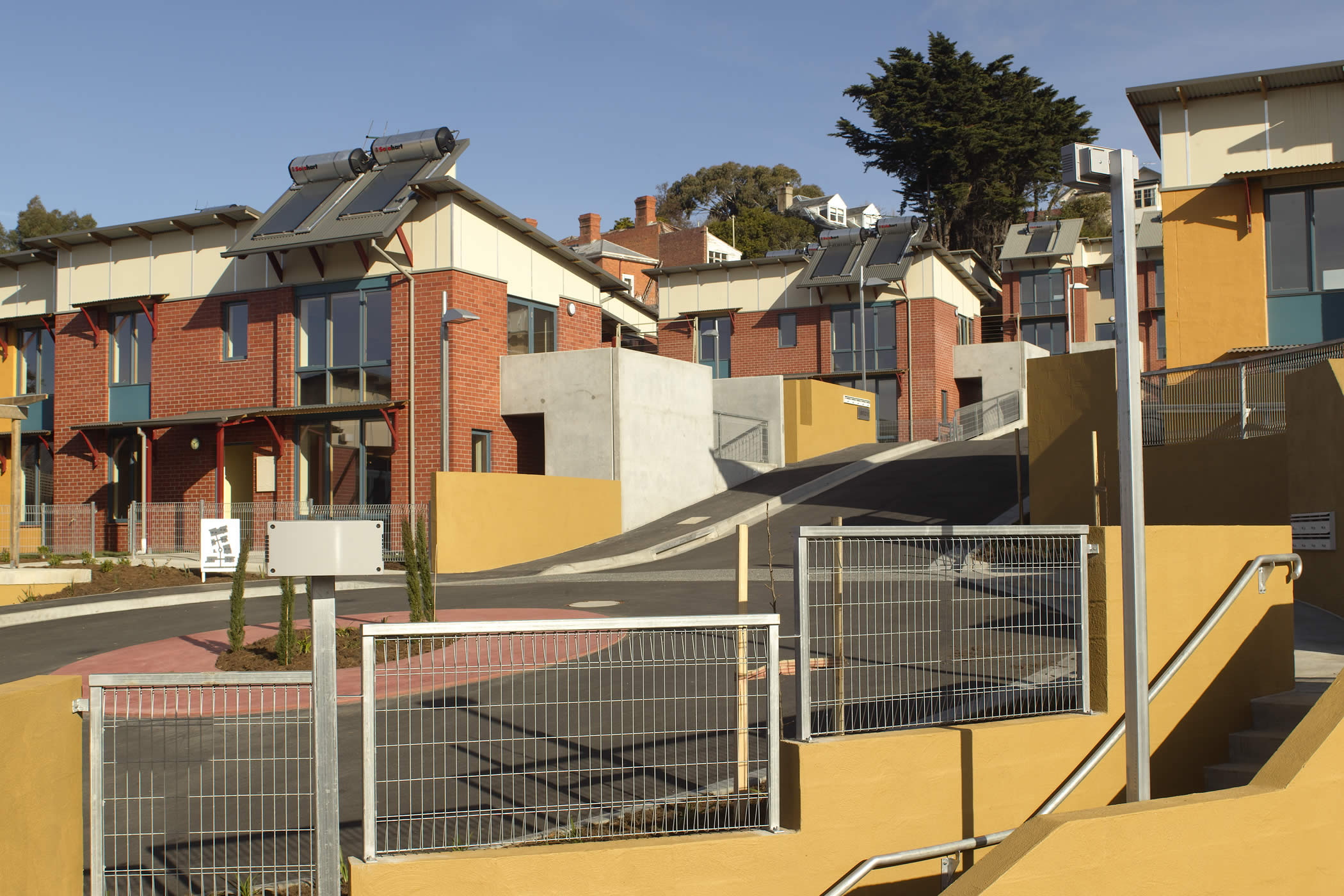 Walford Terraces, Hobart: Generous wall thickness for good insulation, trombe walls and solar roof panels are some of the design devices achieving low energy bills for DHHS tenants in this popular social housing project. Photo by Peter Whyte.